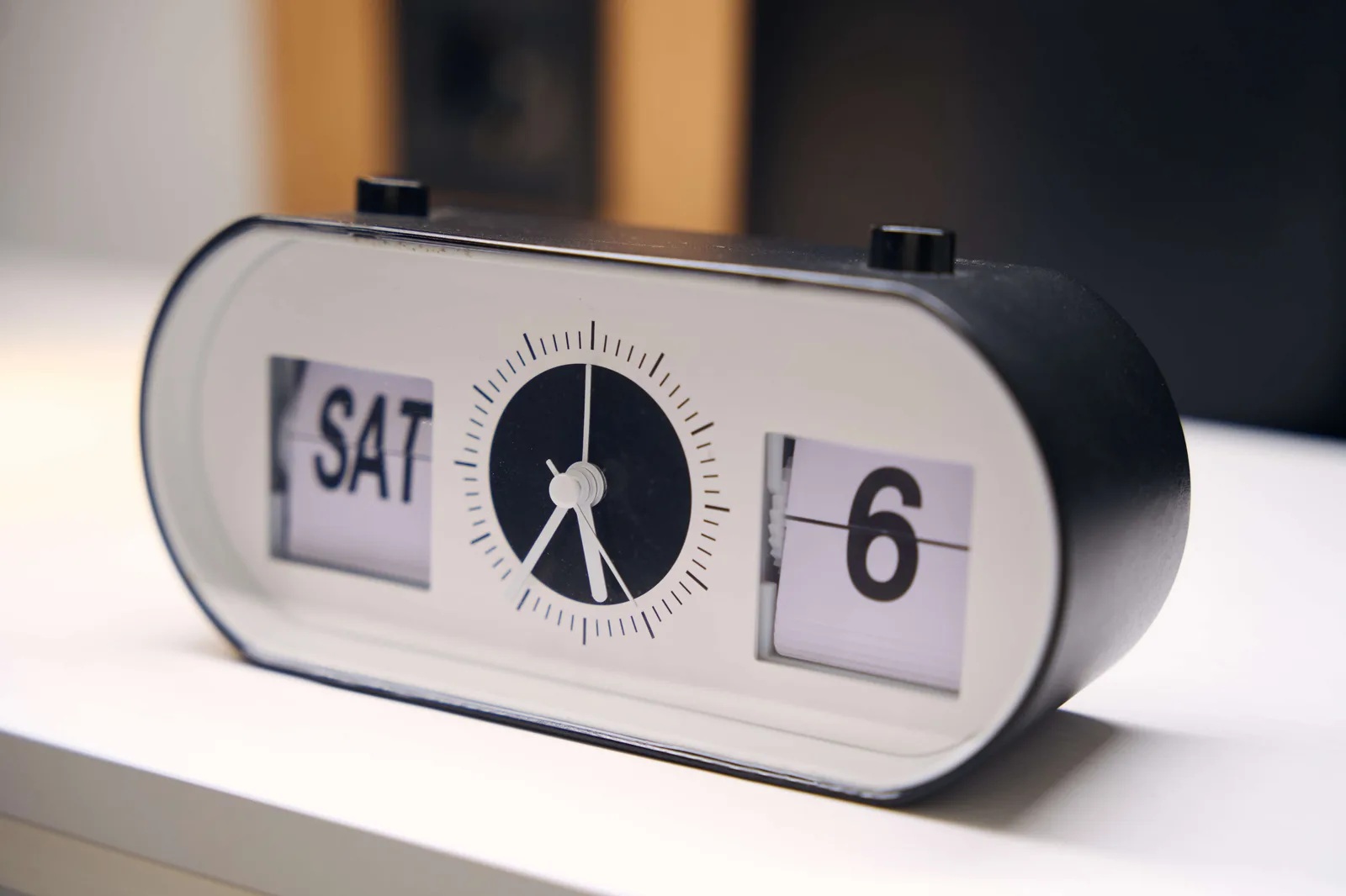 On the bedside table there is a modern electronic alarm clock, on the display Saturday, the sixth day