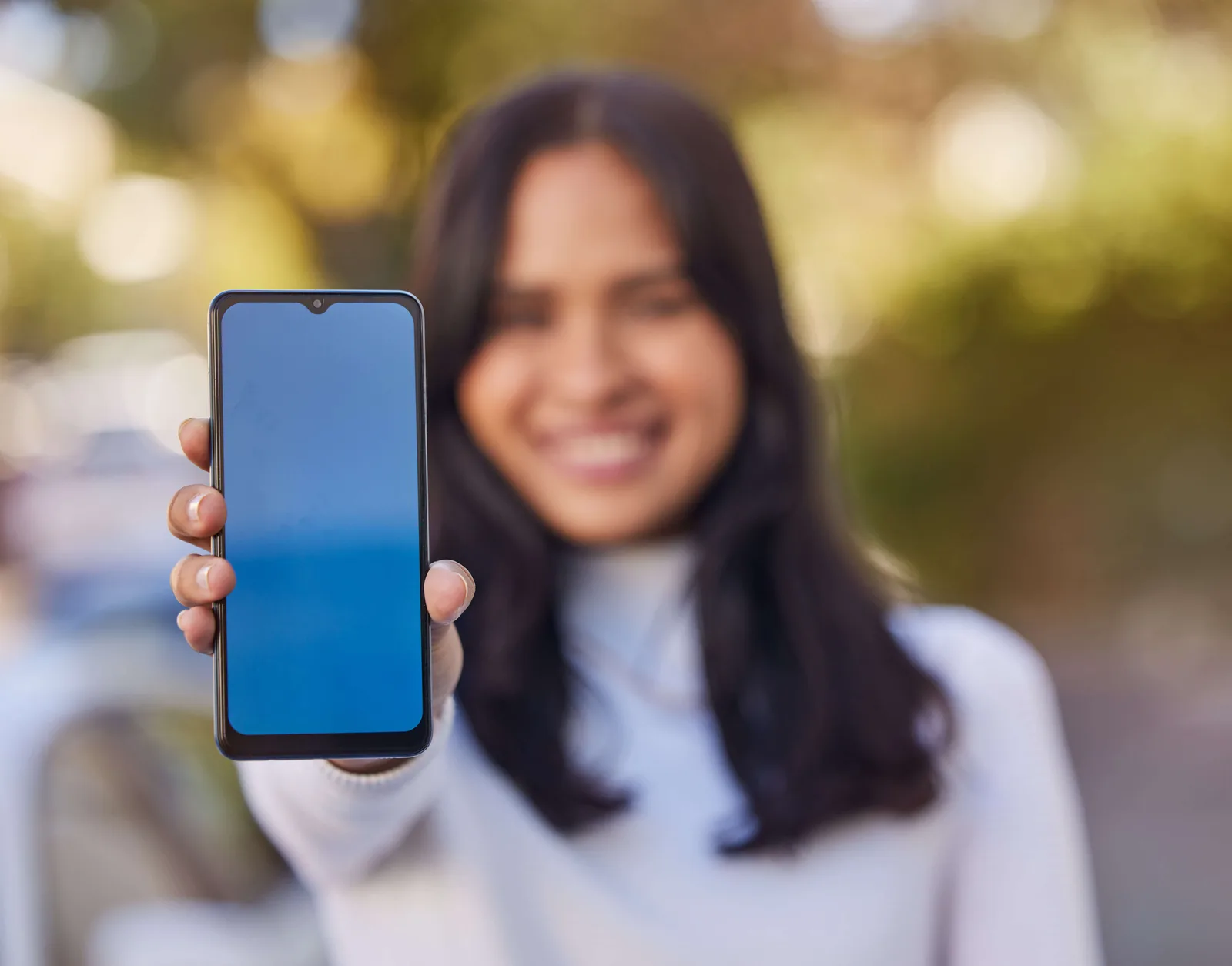 Woman, hands holding phone