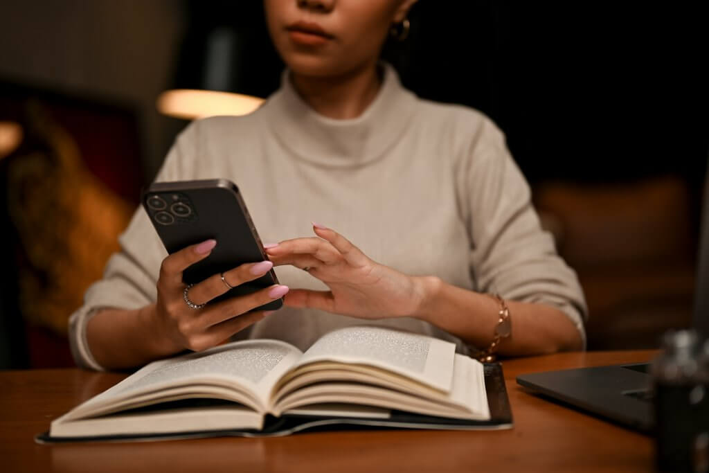 Female Using Her Smartphone while studying