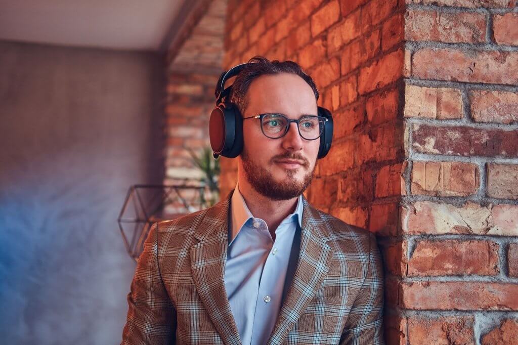 male media or radio rep listening to an ai-powered spec spot created by spoton